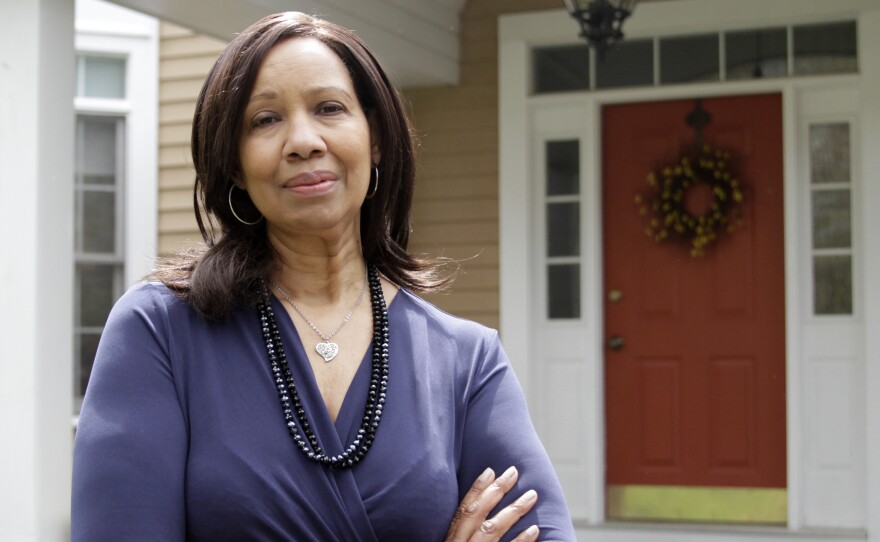 Colette Baptiste-Mombo stands in front of her home in Connecticut.