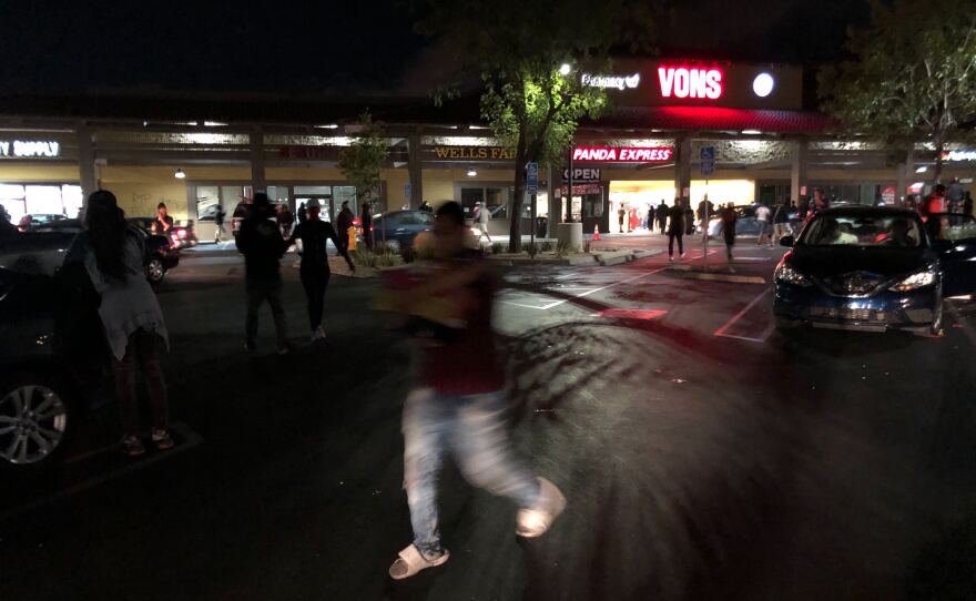People rush in and out of Vons as protesters gather in La Mesa on May 30, 2020.