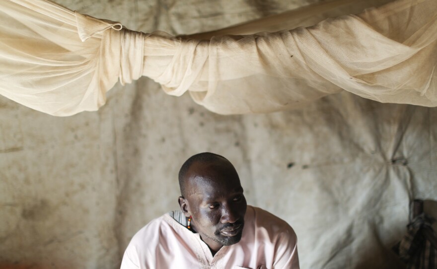 David, a South Sudanese health worker at the MSF facility, sits on his bed in his shelter. He's one of the 124,000 people who've come to the camp to escape the fighting. We were asked by MSF only to use the first names of local employees for security reasons.