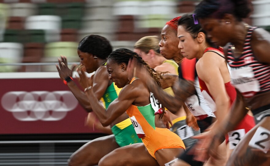Ivory Coast's Marie-Josee Ta Lou (2L) runs to win the women's 100m semi-final 2 on July 31.