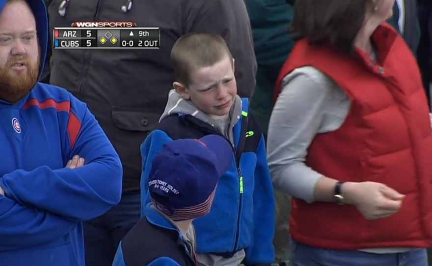 A young fan reacts to the Cubs blowing a lead in the ninth inning.