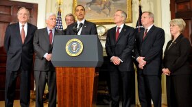 President Obama is surrounded by Democratic senators after a meeting to discuss health care reform legislation on Jan. 15, 2009.  The health care battle and other issues have hurt Democrats among voters as they head into this year's midterm election.