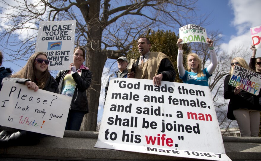 Allan Hoyle of North Carolina (center) protests gay marriage outside the Supreme Court on Wednesday.