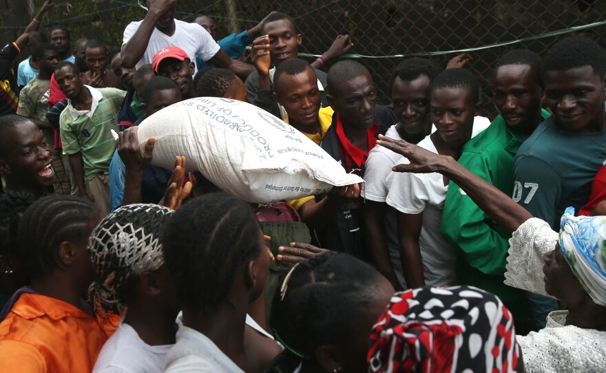 The Liberian government delivered bags of rice, beans and cooking oil to residents of the West Point slum in Monrovia. The community has been quarantined due to the Ebola outbreak in the area.