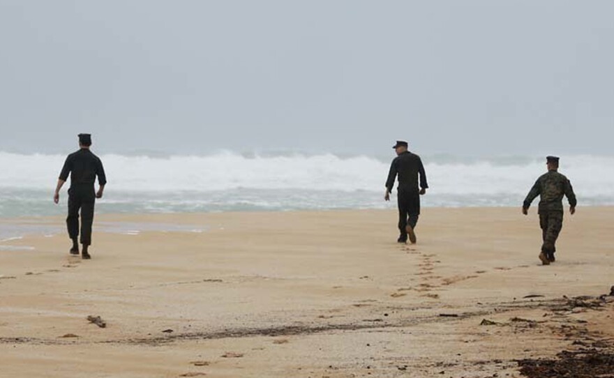 Members of Marine Heavy Helicopter Squadron 463 search for debris on Friday, after two helicopters crashed off Oahu's coast. The search for survivors has now been called off.