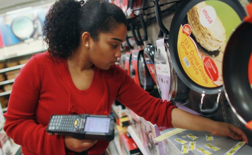Joanely Carrero restocks shelves at a Target store in Miami. Retailers added 12,000 jobs last month.
