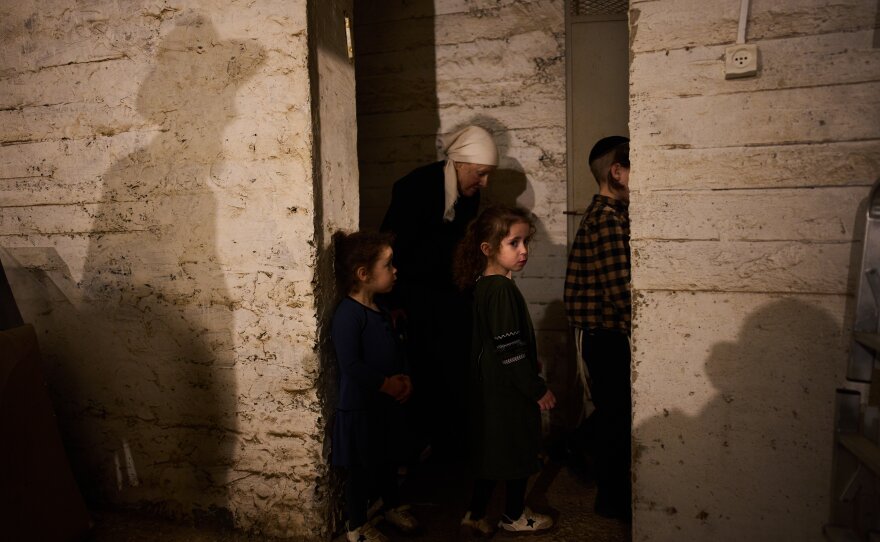 People take cover in a bomb shelter as air raid sirens warn of incoming Iranian missile strikes in Bnei Brak, Israel, Wednesday, April 1, 2026.