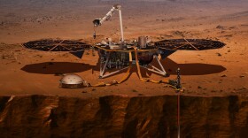 This illustration made available by NASA in 2018 shows the InSight lander drilling into Mars. 