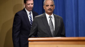 Former Attorney General Eric Holder and FBI Director James Comey at a news conference at the Justice Department in Washington, D.C., June 30, 2014. 