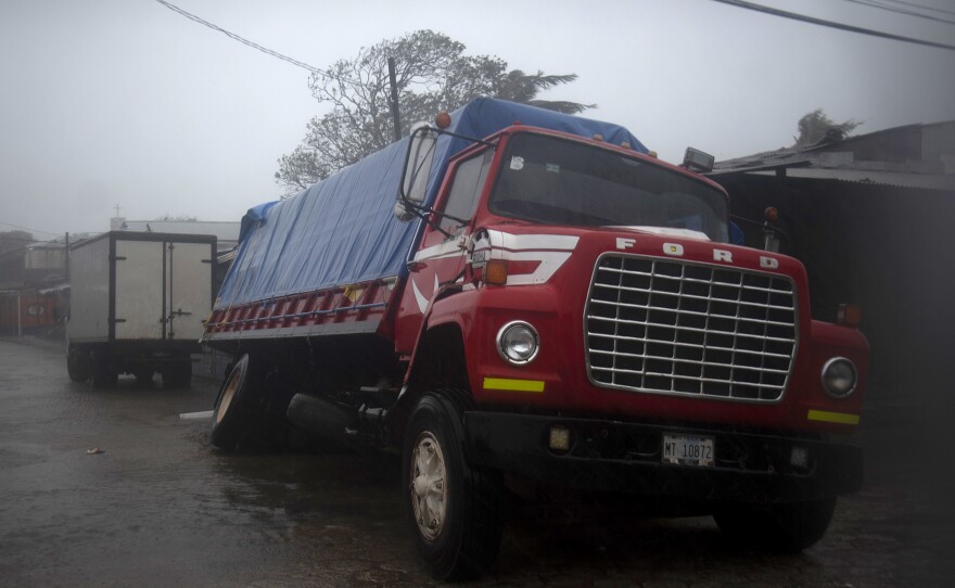 A truck flounders in a flooded street in Puerto Cabezas, Nicaragua, just hours before Hurricane Iota made landfall in the country Monday night. By Tuesday morning, the storm had significantly weakened, but it still poses life-threatening dangers for residents in its path.