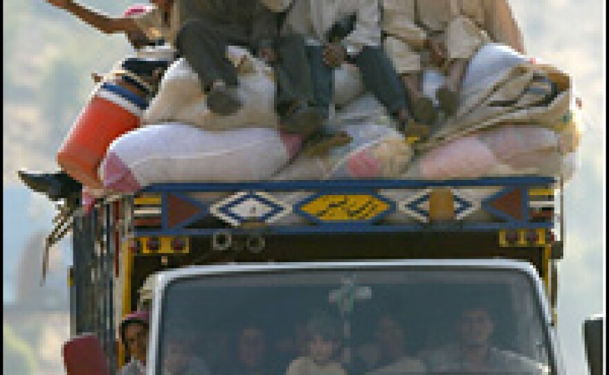 A truck crosses into Syria Monday. Foreigners and Lebanese residents are evacuating Lebanon to escape the dangers of Israeli attacks.