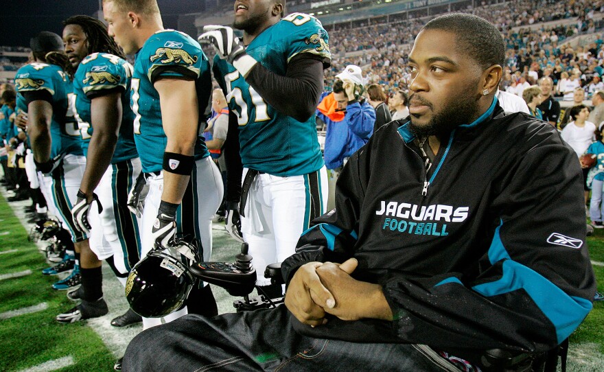 Jacksonville Jaguars player Richard Collier joins his teammates on the sidelines for the national anthem on Dec. 18, 2008.