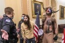 FILE - In this Jan. 6, 2021 file photo, supporters of President Donald Trump, including Navy veteran Jacob Chansley, right with fur hat, are confronted by U.S. Capitol Police officers outside the Senate Chamber inside the Capitol in Washington.