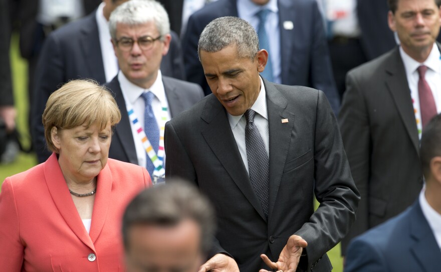 President Obama and German Chancellor Angela Merkel walk to a group photo of G-7 leaders in June.