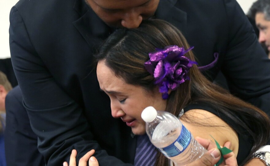 Nelba Marquez-Greene and her husband, Jimmy Greene, embrace during a news conference on Jan. 14, 2013 — one month after their daughter, Ana Grace Marquez-Greene, 6, was killed in the Sandy Hook Elementary School massacre in Newtown, Connecticut.