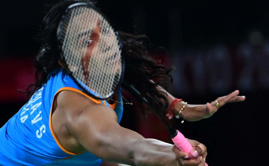 India's P. V. Sindhu hits a shot to China's He Bingjiao in their women's singles badminton bronze medal match on August 1.