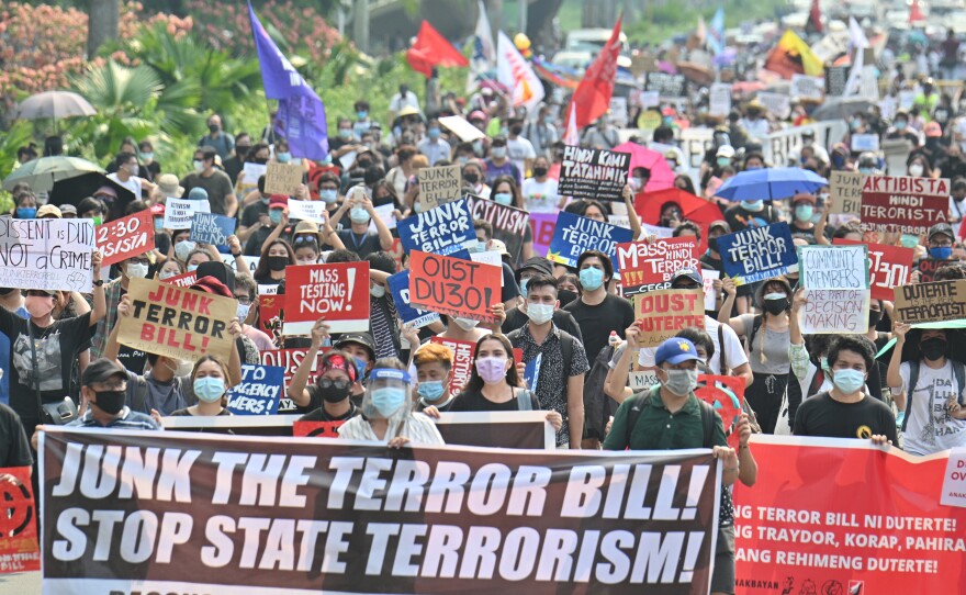 Hundreds of demonstrators carry anti-terrorism bill placards as they march at a university campus in Manila on June 4, 2020, a day after lawmakers passed the sweeping legislation. The Philippines' Supreme Court upheld most of the law in a partial verdict announced this week.