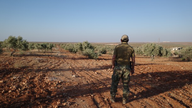 A senior Uyghur militant stands in an olive grove in northern Syria, where Uyghur commanders say their fighters began an ultimately successful assault on Syrian regime forces in November 2024.