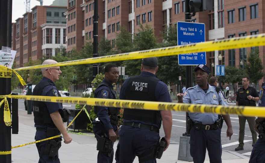 Police monitor the scene near the Navy Yard. Shots were fired around 8:20 a.m.