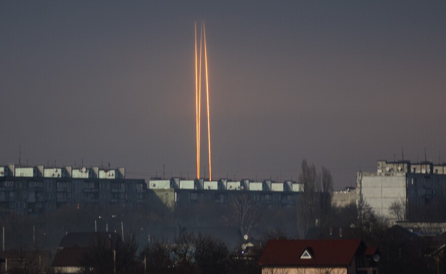 Three Russian rockets launched against Ukraine from Russia's Belgorod region are seen at dawn in Kharkiv, Ukraine, late Thursday, March 9, 2023.