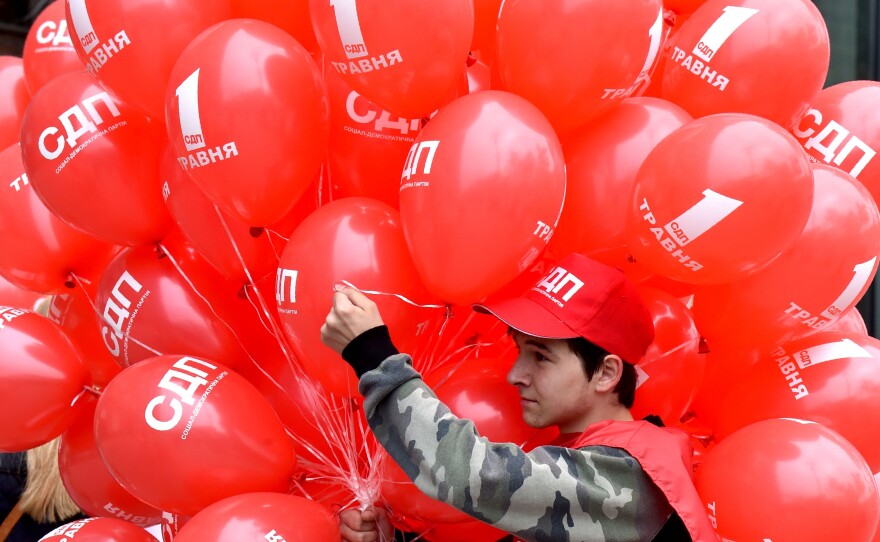 A young activist holds red balloons during a May Day rally organized by Ukrainian left-wing parties and trade unions in Kiev on Monday.