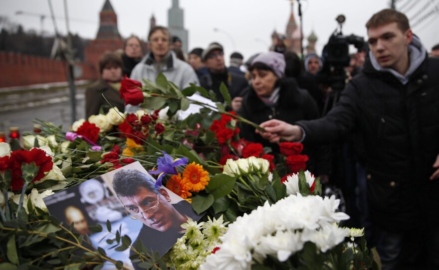 People lay flowers on Saturday at the place where Boris Nemtsov, a charismatic Russian opposition leader and sharp critic of President Vladimir Putin, was gunned down, at Red Square in Moscow, Russia.