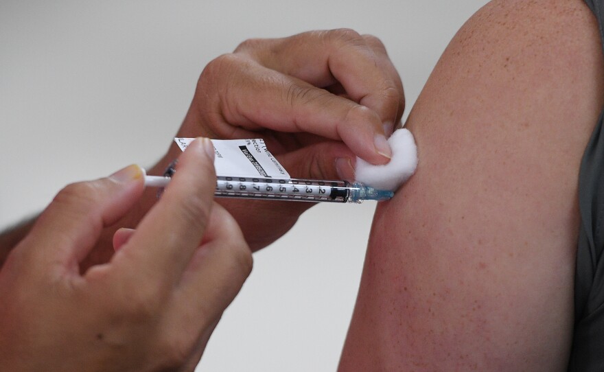 A health care worker in Sydney, Australia receives their COVID-19 vaccination this month. Italian authorities got the European Commission to block a shipment of 250,700 doses of vaccine destined for Australia from Europe this week.