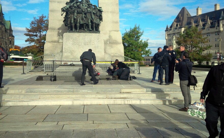 A Canadian soldier who was shot outside the war memorial on Parliament Hill in tended to in Ottawa on Wednesday.