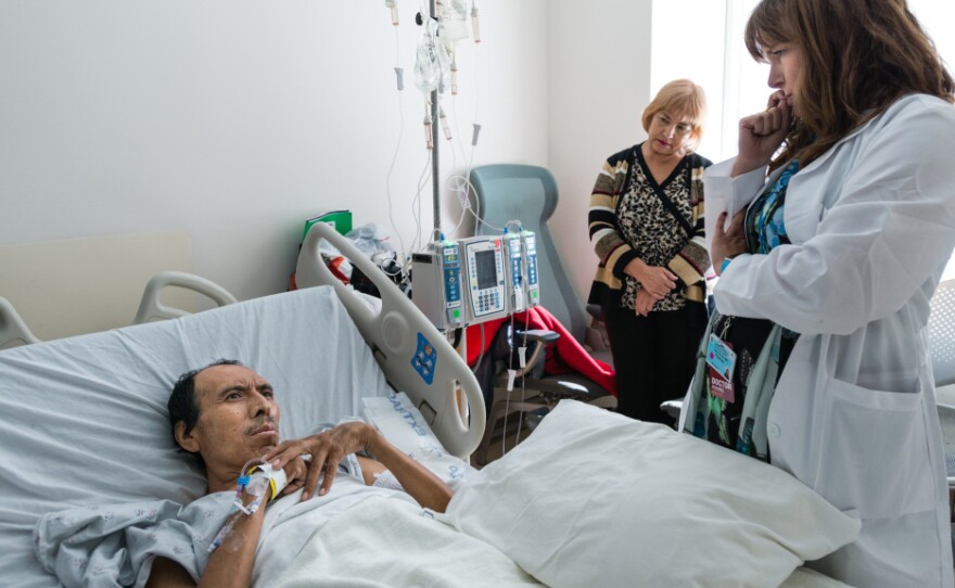 Dr. Carin van Zyl talks to patient Jose Garcia Flores about his treatment options for his advanced stage colon cancer in October 2015.