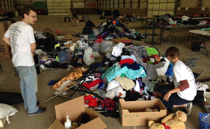 DePauw University Sustainability Director Anthony Baratta and Amber Hecko, assistant director of DePauw's Environmental Fellows Program, sort through truckloads of donated goods.