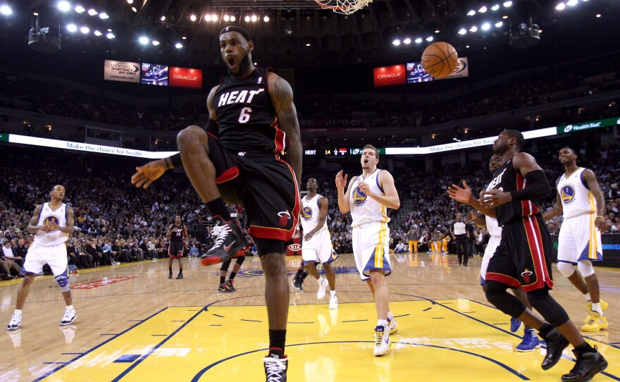 LeBron James reacts after dunking the ball as his Miami Heat played the Golden State Warriors on Jan. 10, 2012, in Oakland, California.