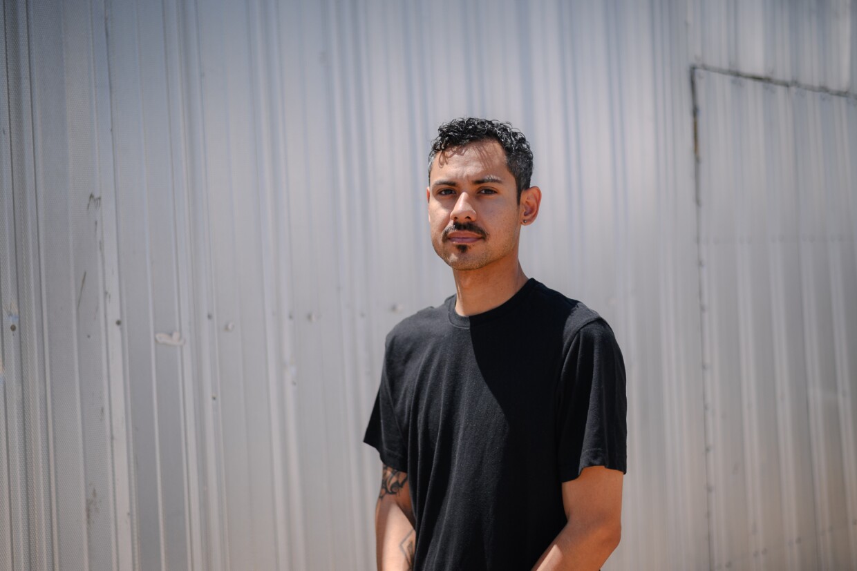 Ryan Perez stands for a portrait at his home in Niland in Imperial County on April 26, 2024. Perez trained as a solar technician in college but says he wasn’t able to find a job when he graduated.