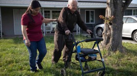 Cristina Hernandez walks with her dad Francisco Rios, 91, across the lawn at her Pomona home in this undated photo. She has been his primary caregiver for 15 years.