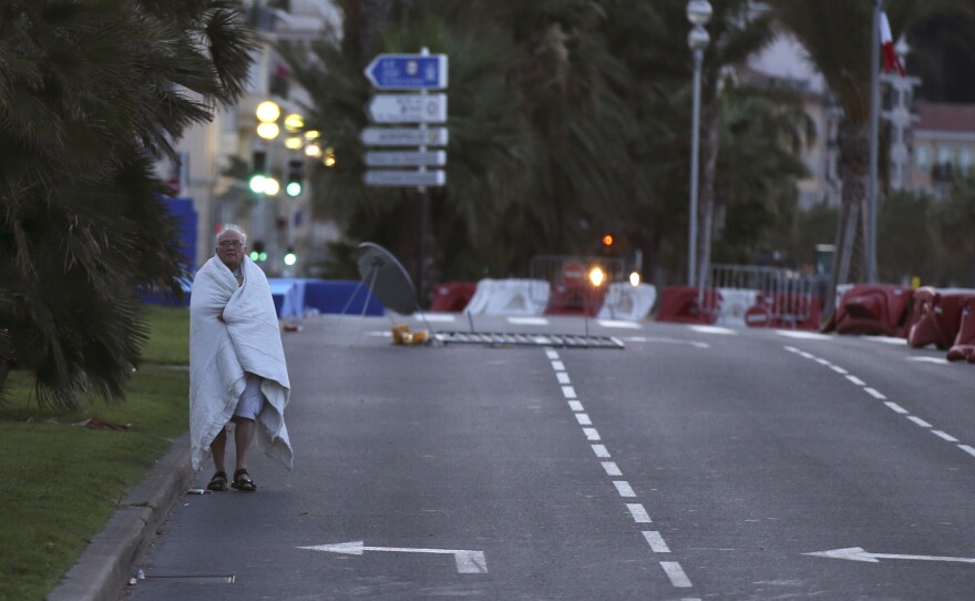 In the early hours of Friday morning, a man walks near the scene of the previous evening's attack.