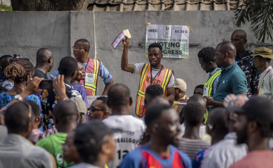 An electoral officer holds up votes as they are counted at a polling station in Lagos, Nigeria