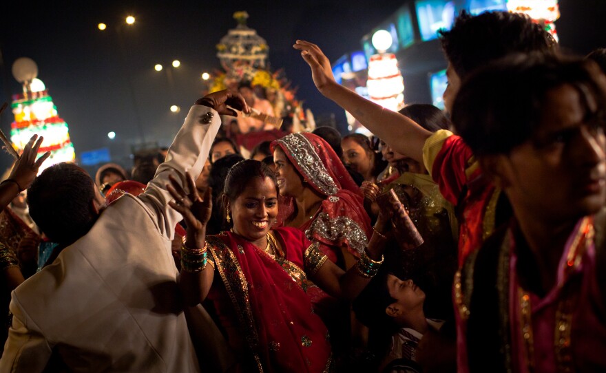 Wedding guests dance at a New Delhi celebration.