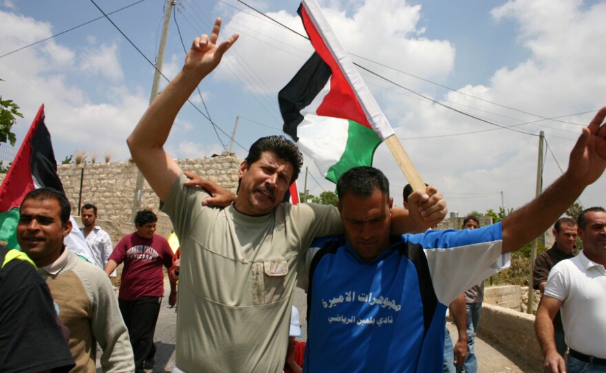 Adeeb and Phil participate in a protest against the Israeli settlements.