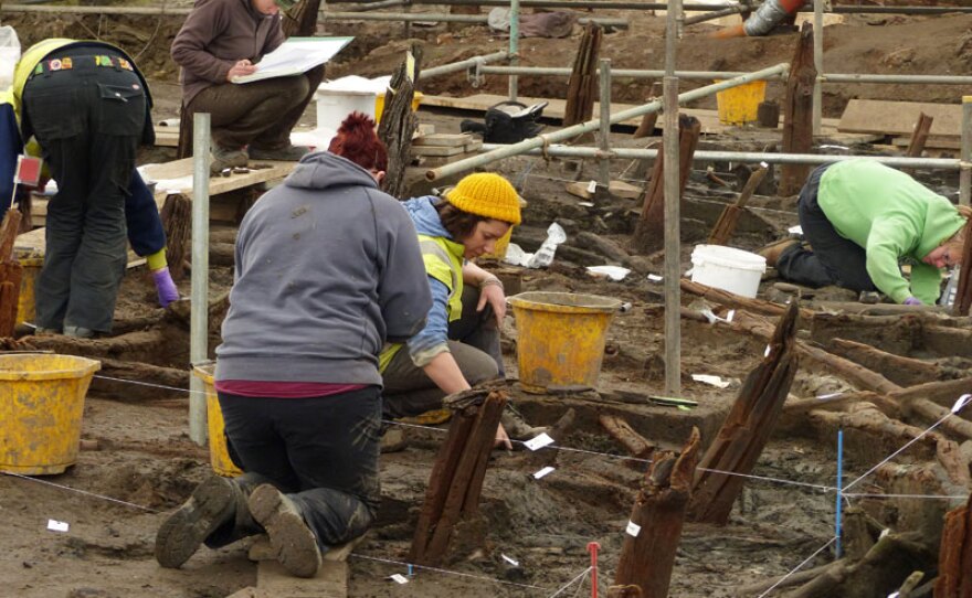 Archaeologists working on different parts of the site, Must Farm Quarry, Britain.