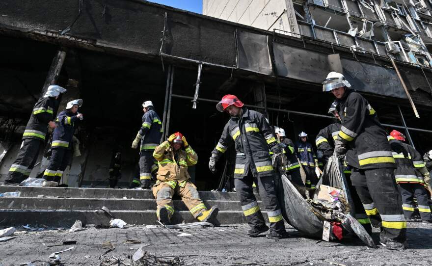 Firefighters remove rubble following a Russian airstrike in the central city of Vinnytsia on Thursday that Ukrainian officials said killed more than 20 people and injured dozens more.