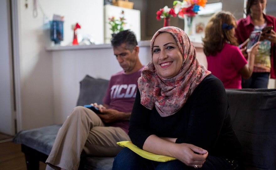 Daliya Ali smiles while sitting alongside her husband in the living space of their El Cajon apartment, July 25, 2017.