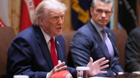 President Donald Trump speaks during a Cabinet meeting at the White House, Wednesday, May 27, 2026, in Washington, as Secretary of Defense Pete Hegseth, looks on.