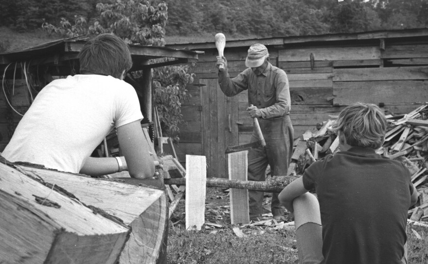 Fiddle player Bill Lamb makes shingles as students watch.