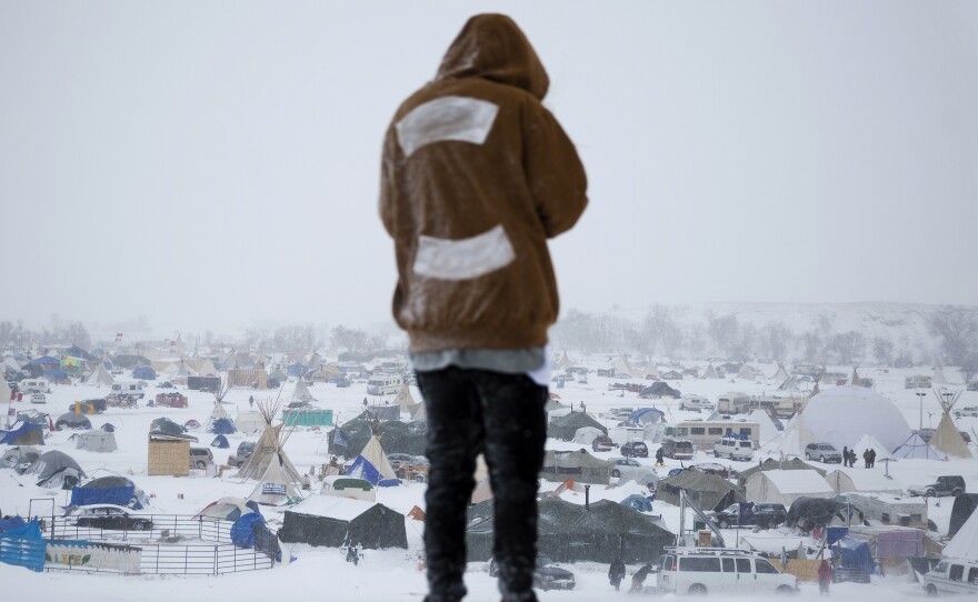 Damin Radford of New Zealand overlooks the Oceti Sakowin camp on Tuesday, where people have gathered to protest the Dakota Access pipeline near Cannon Ball, N.D.