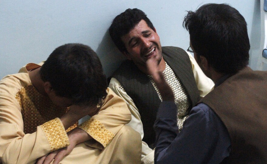 After a suicide attack on a Shiite mosque in Herat, relatives of the victims grieve for the loved ones they lost in the violence Tuesday.