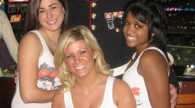 Hooters employees with a Marine