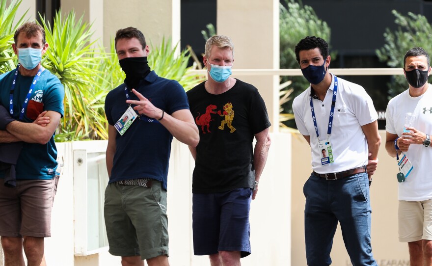 People associated with the Australian Open are seen lining up at a testing facility at the View Hotel on Thursday in Melbourne, Australia. Victoria state has reintroduced COVID-19 restrictions after a hotel quarantine worker tested positive for the coronavirus on Wednesday.