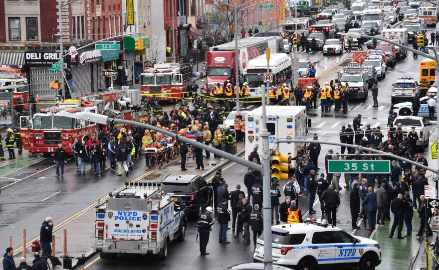 Members of the New York Police Department and emergency vehicles crowd the streets after at least 13 people were injured during a rush-hour shooting at a subway station in the New York borough of Brooklyn on Tuesday.