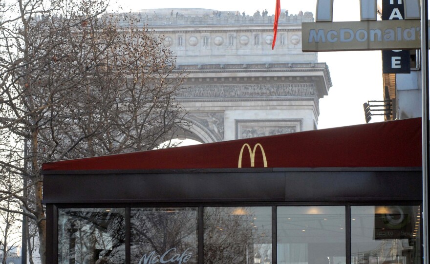 The Arc de Triomphe is visible behind a McDonald's restaurant on the Champs Elysees in Paris, France. The nation is now McDonald's second-biggest market, but one historic neighborhood known as "the belly of Paris" has pledged to keep it out.