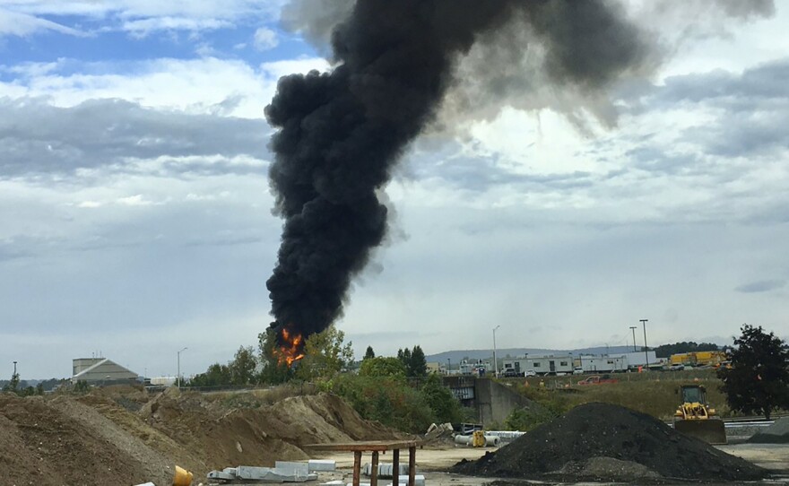 Smoke fills the sky after a World War II-era plane crashed Wednesday at Bradley International Airport north of Hartford, Conn.