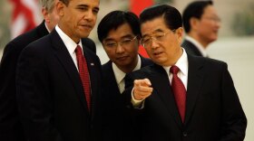 President Obama  listens to Chinese President Hu Jintao as they attend a state dinner reception Tuesday at the Great Hall of the People in Beijing. Standing behind them are their translators.